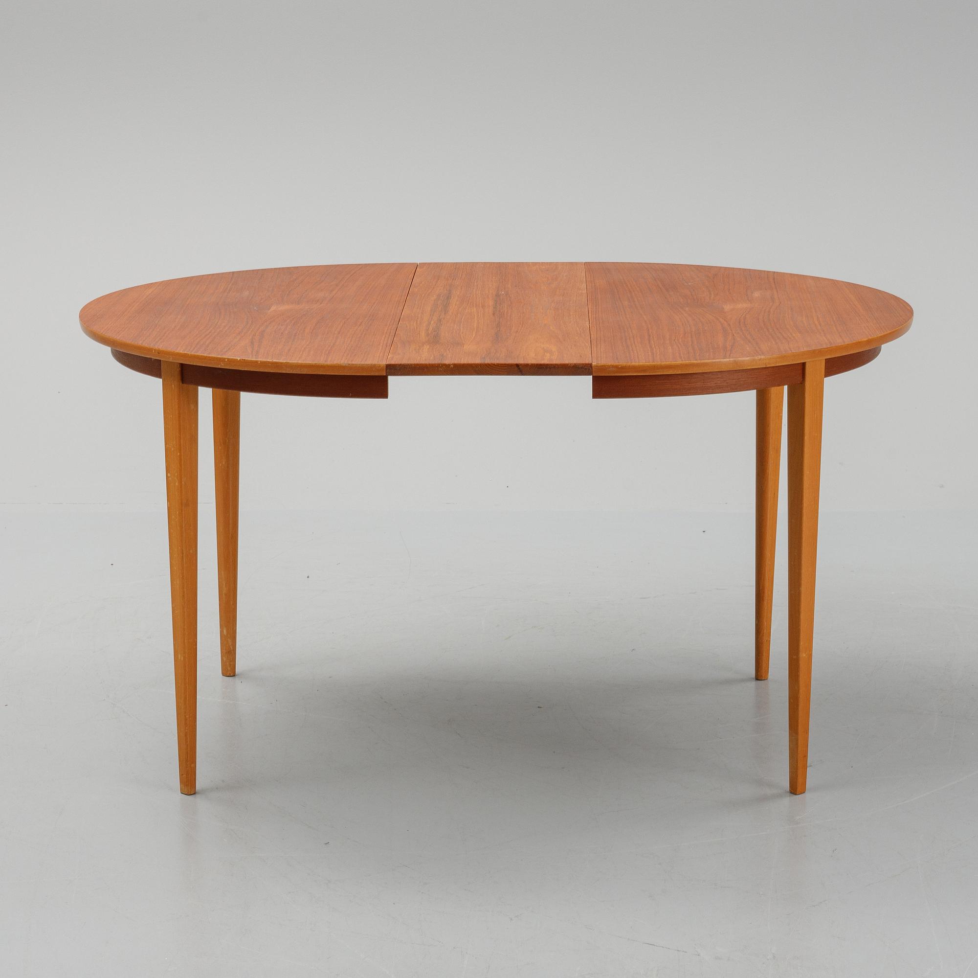 A teak dining table with 4 'Monaco' chairs, mid 20th century.