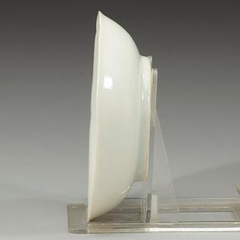 A white-glazed moulded small dish, Qing dynasty, 18th century.