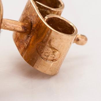 A pair of 14K gold earrings.