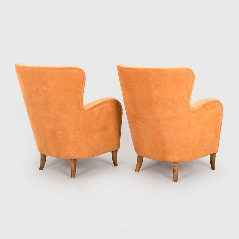A pair of mid-20th century armchairs.
