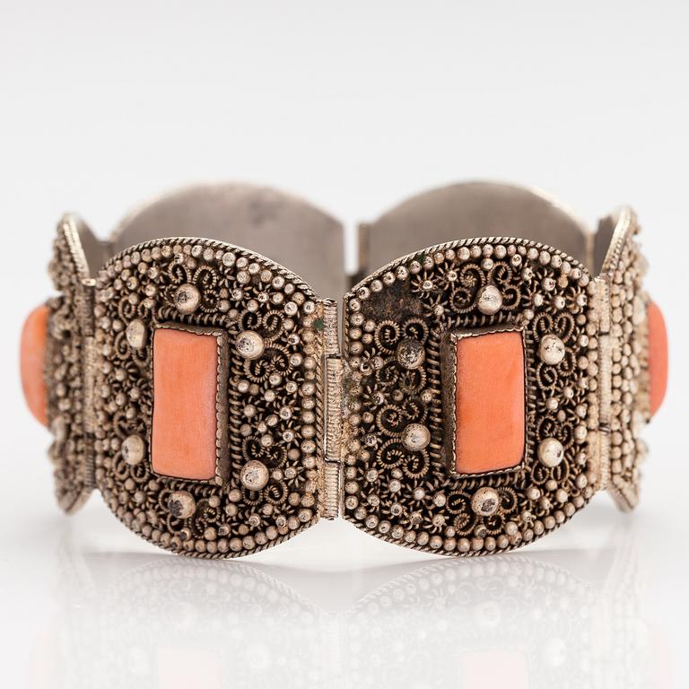 A silver bracelet with corals.