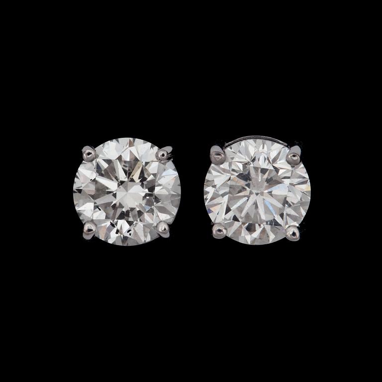 A pair of diamond, 1.00 ct and 1.00 ct G/VS2, earrings.