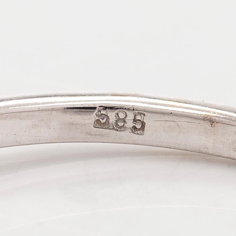A 14K white gold ring with brilliant-cut diamonds.