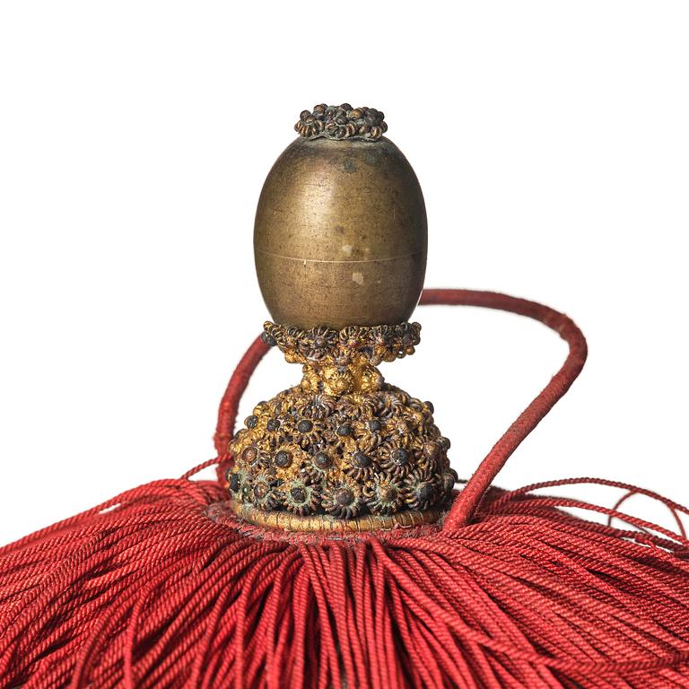 Two boxes with a mandarin's summer hat and black satin autumn hat and feather with six mandarin hat insignias.