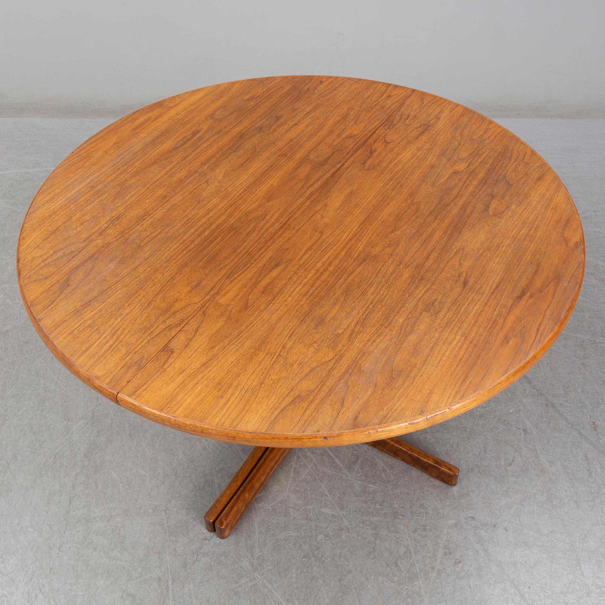 A walnut vereered dining table, mid 20th Century.