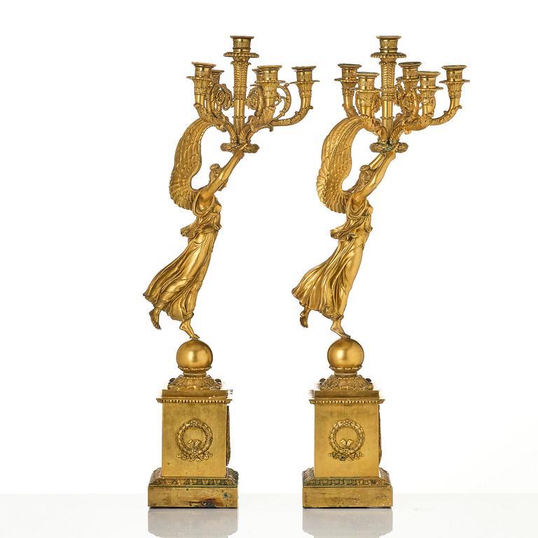 A pair of six-branch gilt bronze Empire candelabra, Paris, early 19th century.