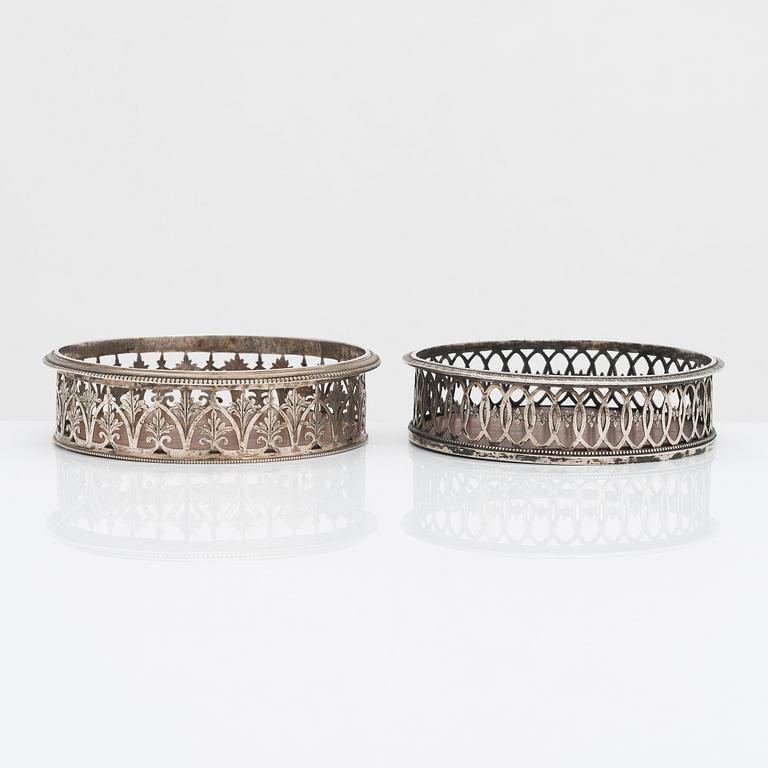 Two French, early 19th-century silver bottle coasters.