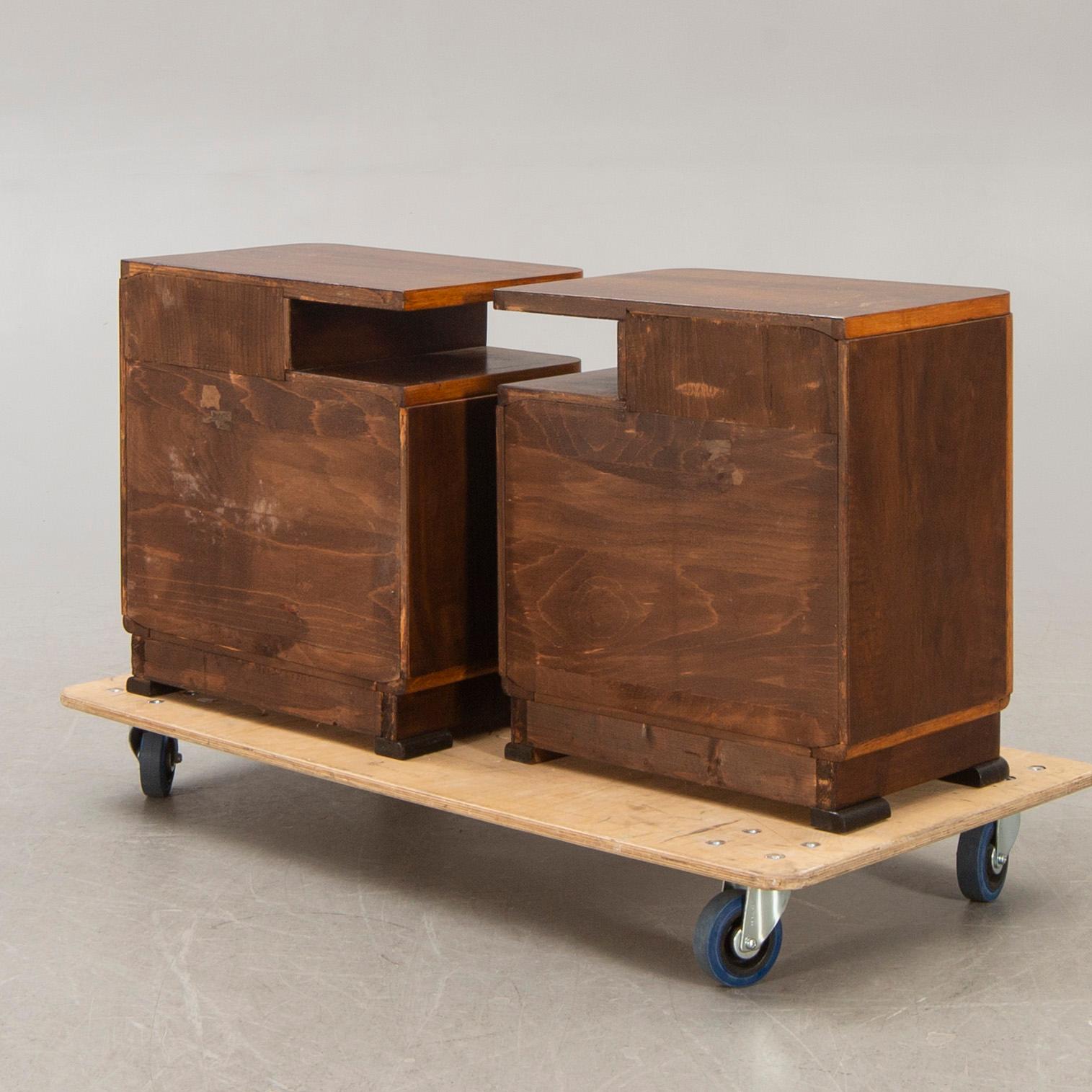 A pair of walnut/mahogany bedside tables first half of the 20th century.