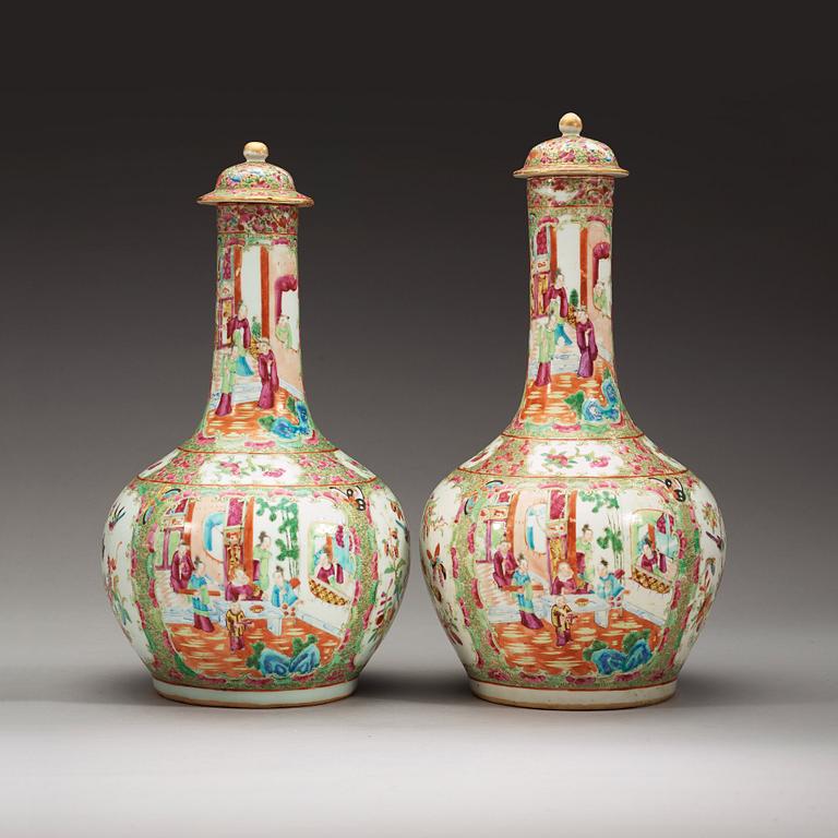 A pair of famille rose Canton vases with covers, Qing dynasty, 19th Century.