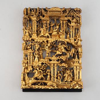 A carved and gilded wooden and metal panel, late Qing dynasty, 19th Century.