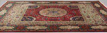 A carpet, semi-antique Tabriz, signed ca 335,5 x 256,5 - 261,5 cm.