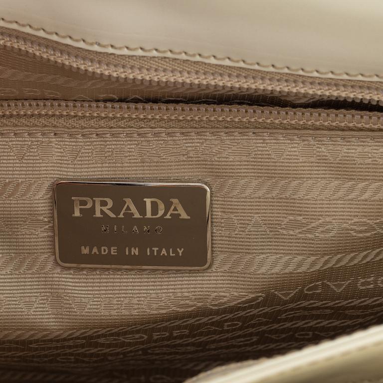 Prada, a beige patent leather bag.