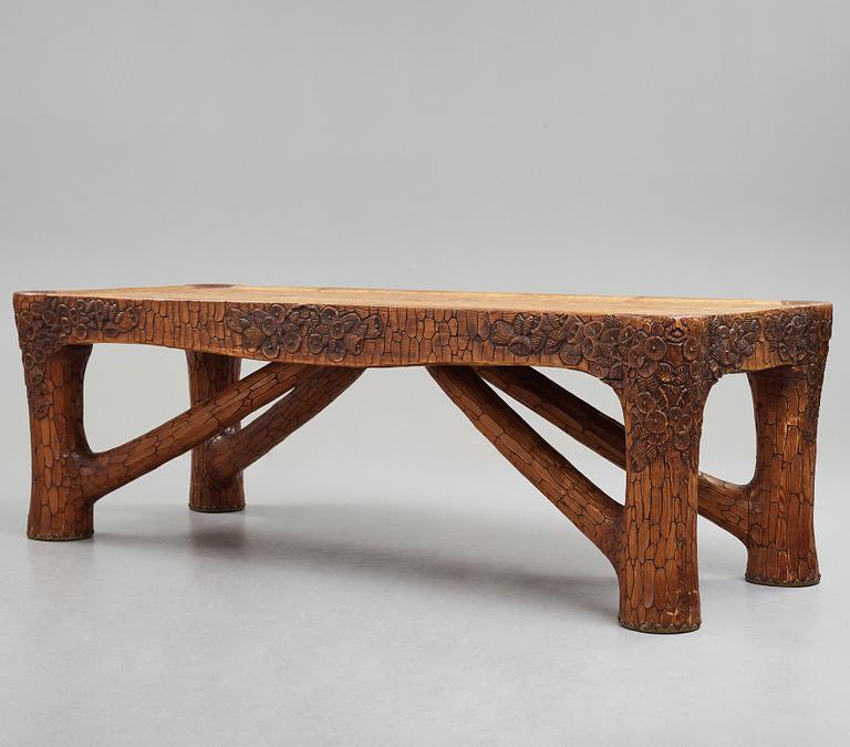 Gustaf Fjaestad, an Art Nouveau carved pine table, Arvika Sweden 1914, a double to the table in the Thiel Collection,