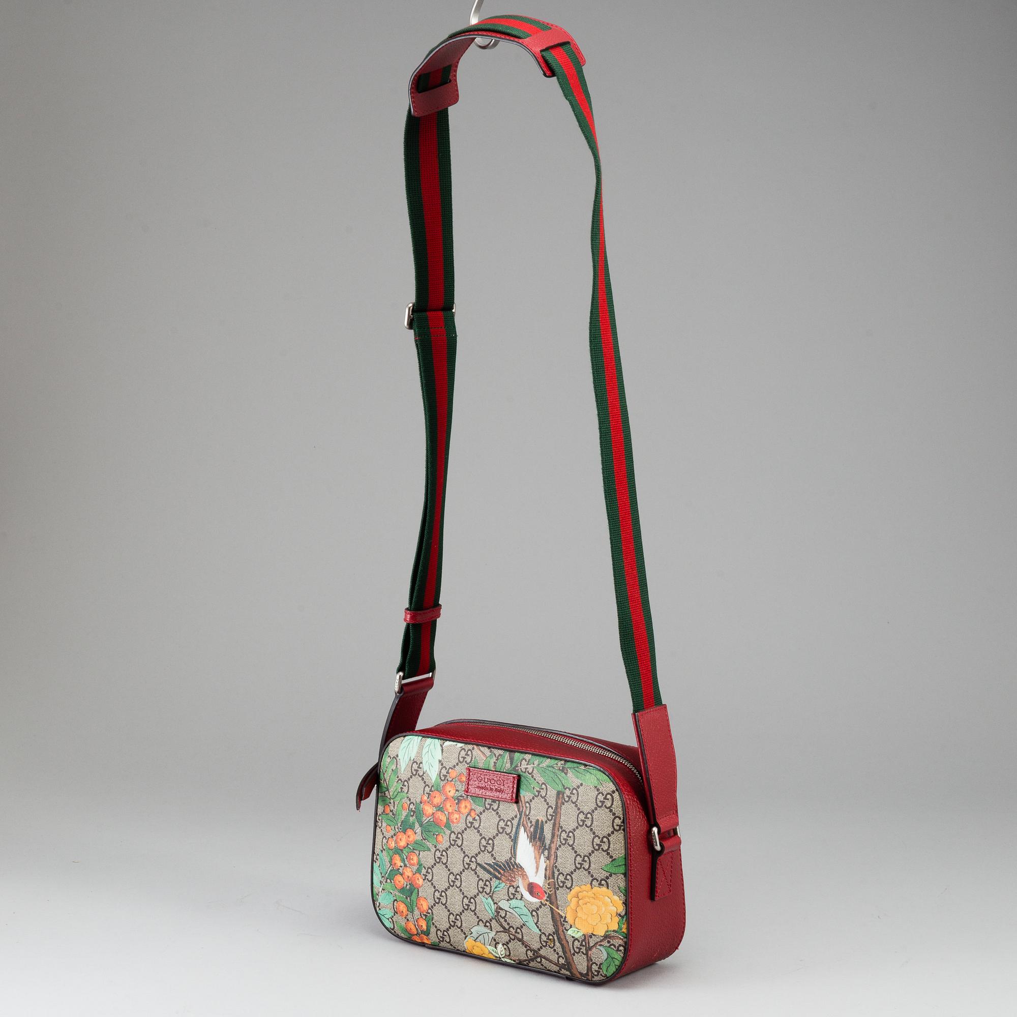 GUCCI, a patterned monogram canvas and leather bag.