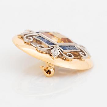 An 18K gold brooch set with a step-cut yellow sapphire possibly synthetic.