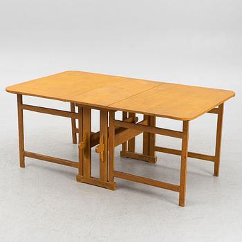 A drop-leaf table, circa 1900.