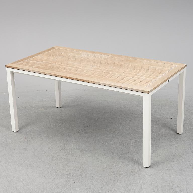 A garden table with four chairs, Gloster.