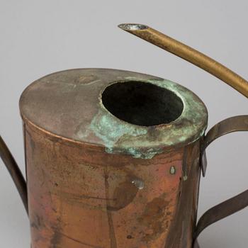 Eight 19th and 20th century copper and brass watering cans.