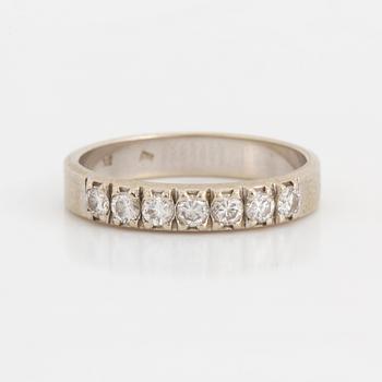 A half-eternity ring set with round, brilliant-cut diamonds.