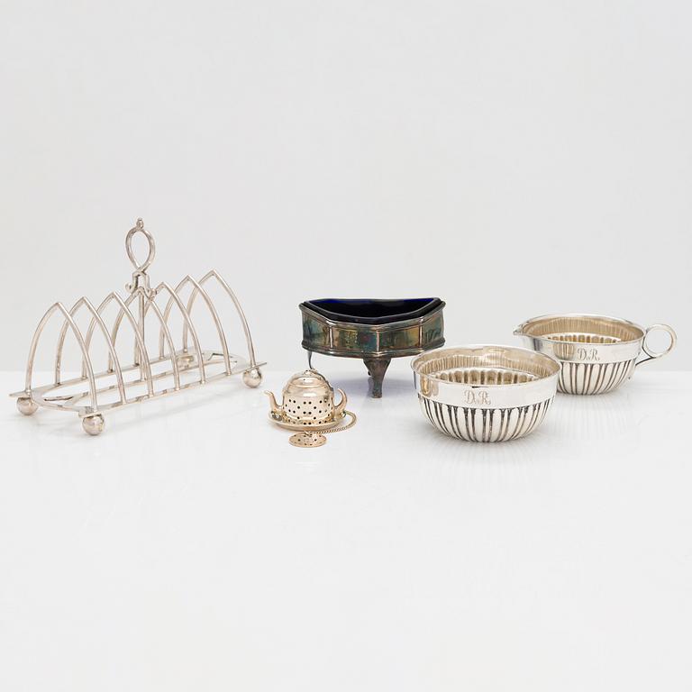 Sterling salt cellar, sugar bowl and creamer, Scotland and Sheffield; silver tea strainer, Turku, and plated toast rack.