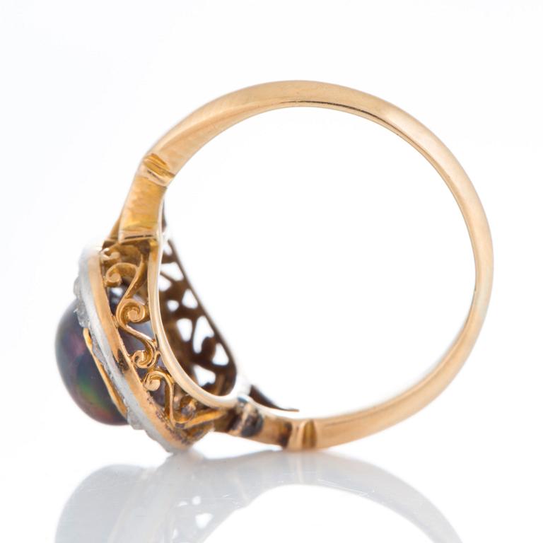 An opal ring set with rose-cut diamonds.