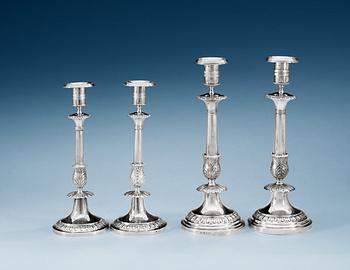 729. Two pairs of Swedish 19th century silver candlesticks, makers mark of Anders Lundqvist, Stockholm 1834 and 1836.