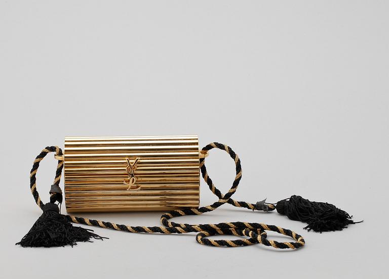 A golden metal evening bag by Yves Saint Laurent.