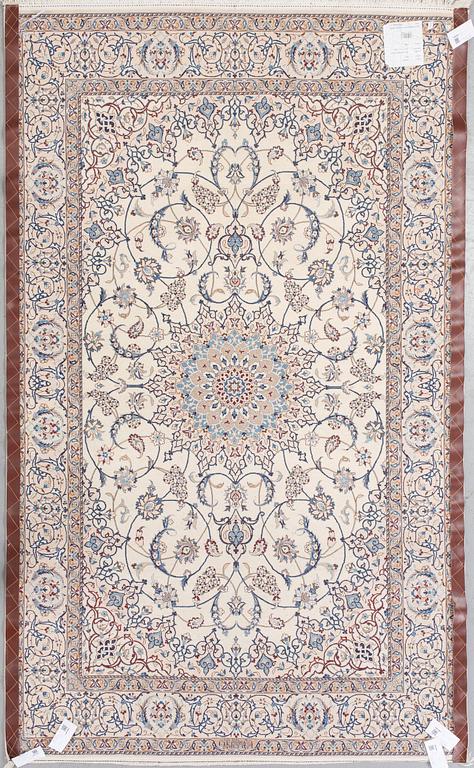 A Nain Habibian rug, part silk. Around 210 x 133 cm.