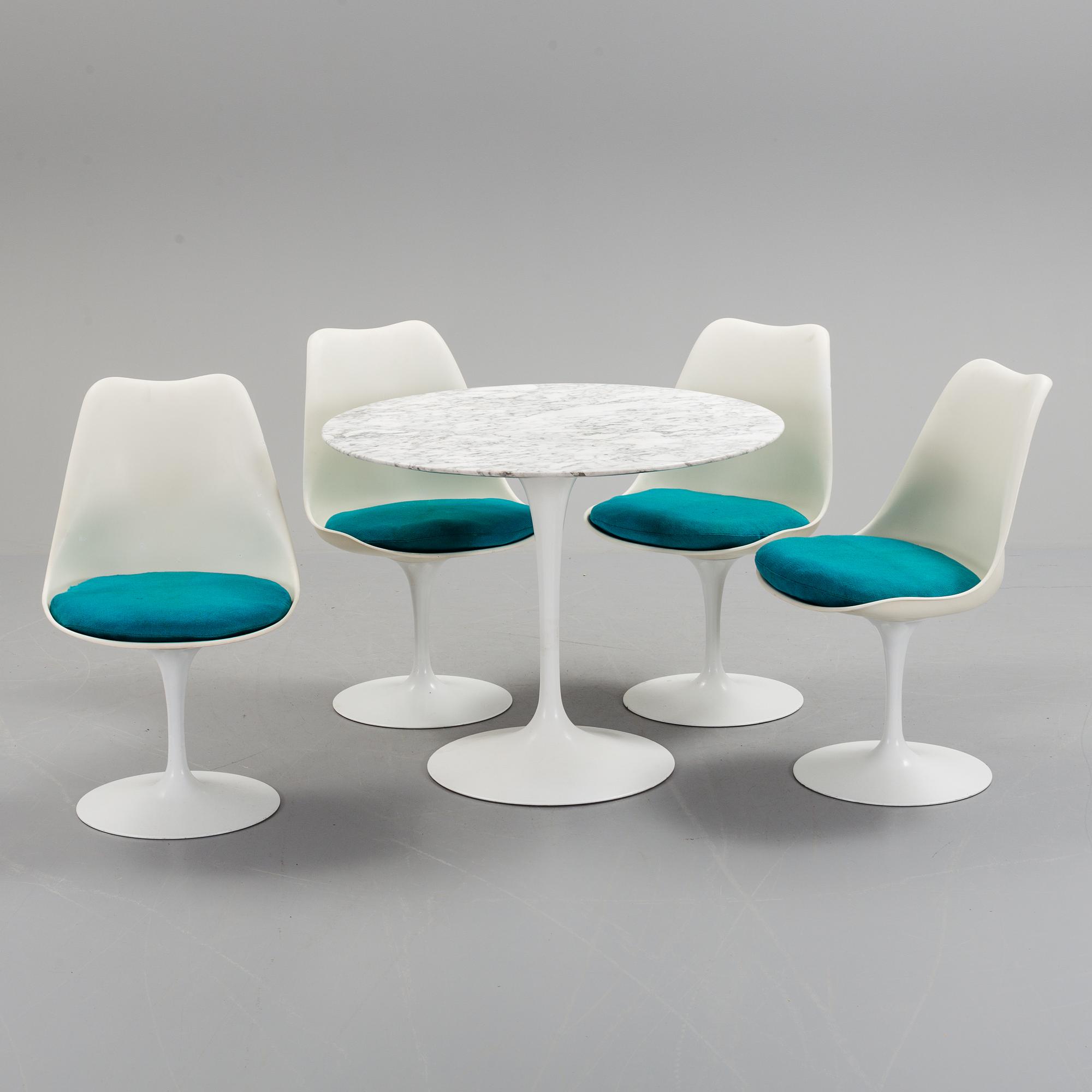 A "Tulip" table and four chairs by Eero Saarinen for Knoll International.