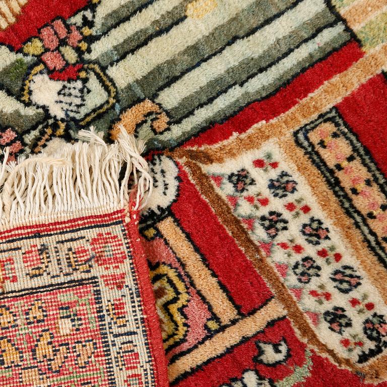 A Kirman rug, semi-antique, ca 78 x 60 cm.