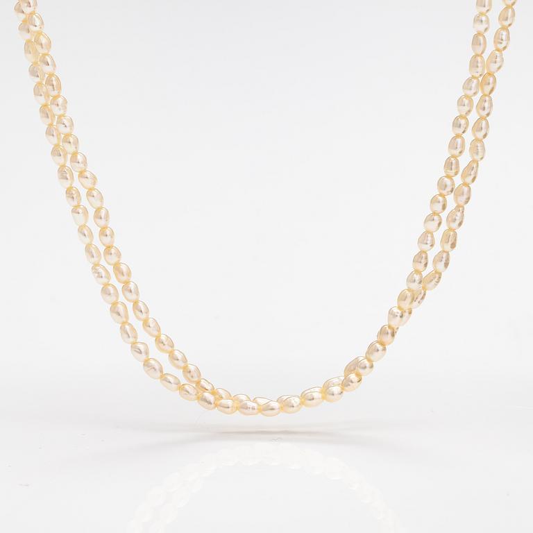 A two-strand pearl collier with cultured pearls and 14K gold clasp.