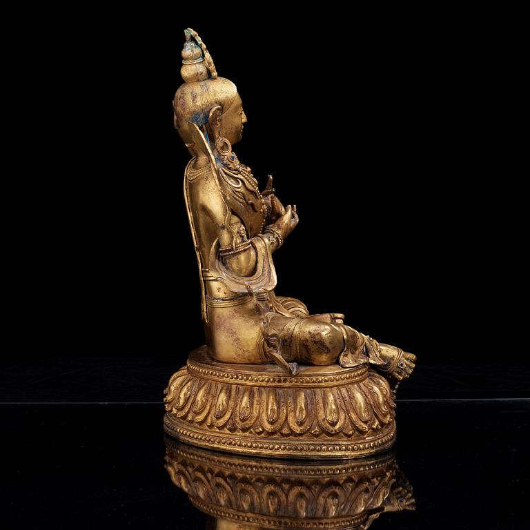 A large gilt bronze figure of Tara, with Qianlong mark.