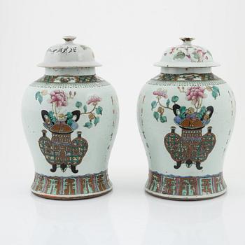 A pair of Chinese lidded urns, late Qing dynasty, around the year 1900.