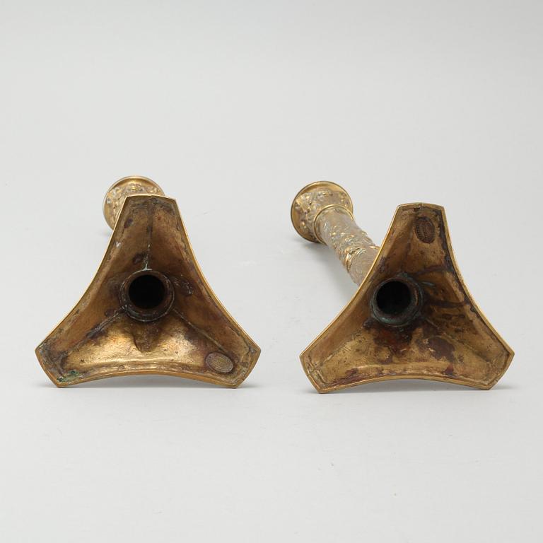 A pair of brass candlesticks from Elkingtons in Birmingham, 19th century.