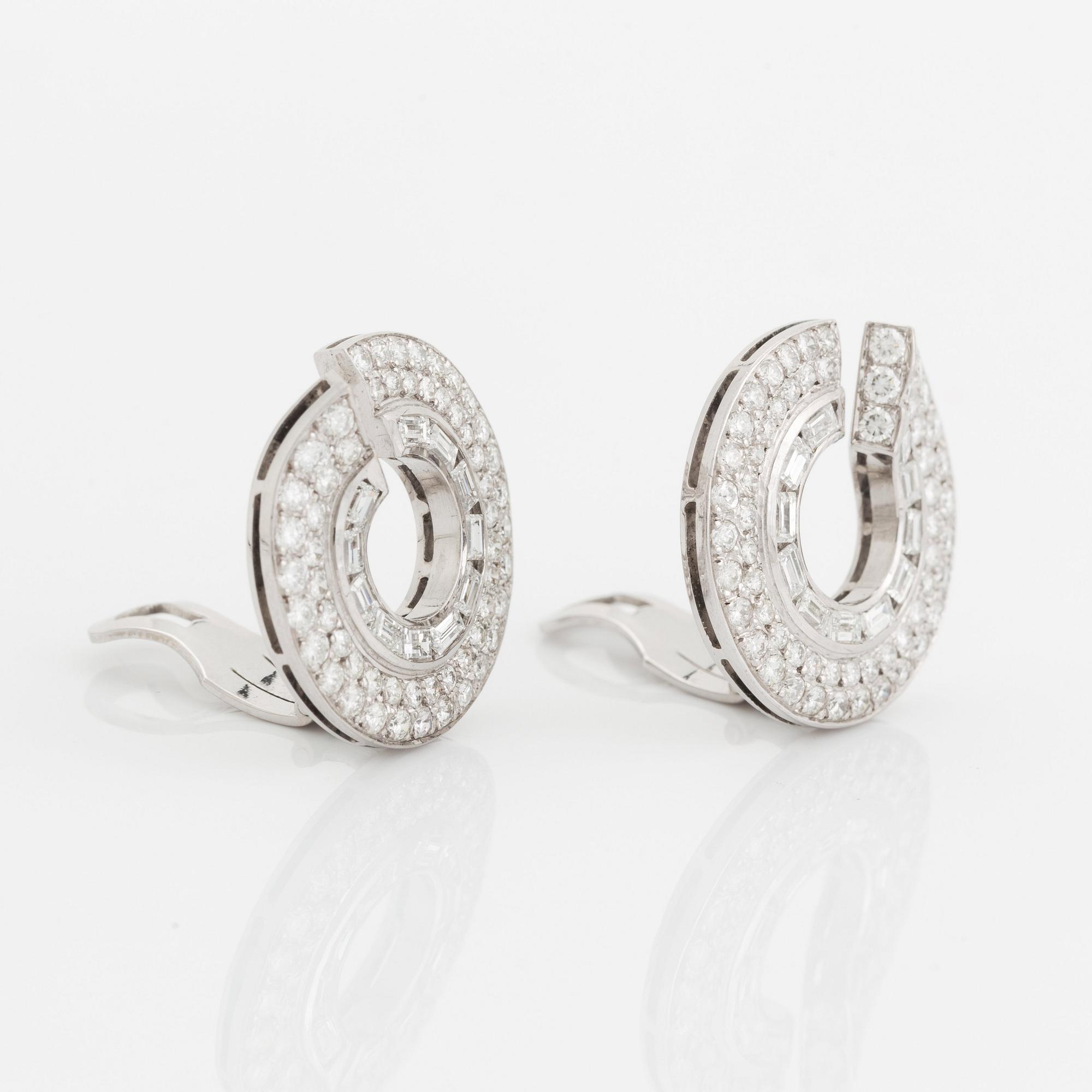 A pair of 14K gold earrings set with round brilliant- and baguette-cut diamonds.