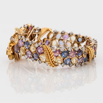 A 1940's multi coloured sapphire and brilliant cut diamond bracelet that can be worn as a clip.