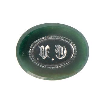 An 18K gold seal/pendant with green stone.
