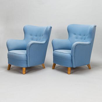 A pair of mid-20th-century armchairs.