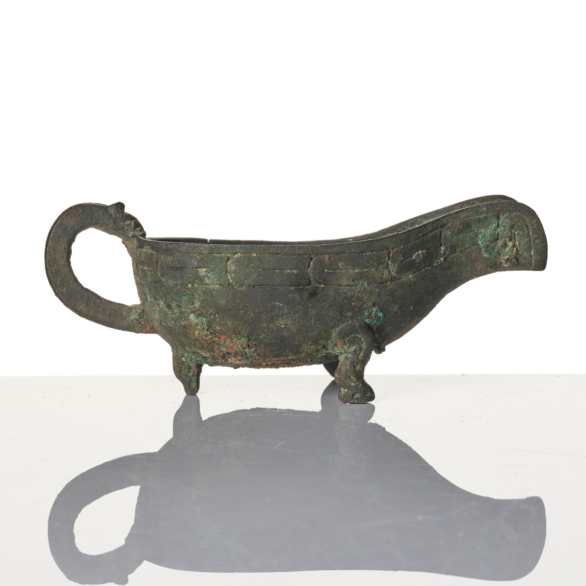 A Chinese brushpot, Qing dynasty, circa 1900. An archaistic bronze ewer and a silvered South East Asian bowl with stand.