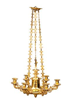529. A CHANDELIER, For sex candles. Fire gilded. Empire style, early 19th century.