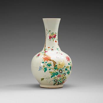 1667. A famille rose vase, China, Republic, 20th Century, with Qianlong four character mark in red.