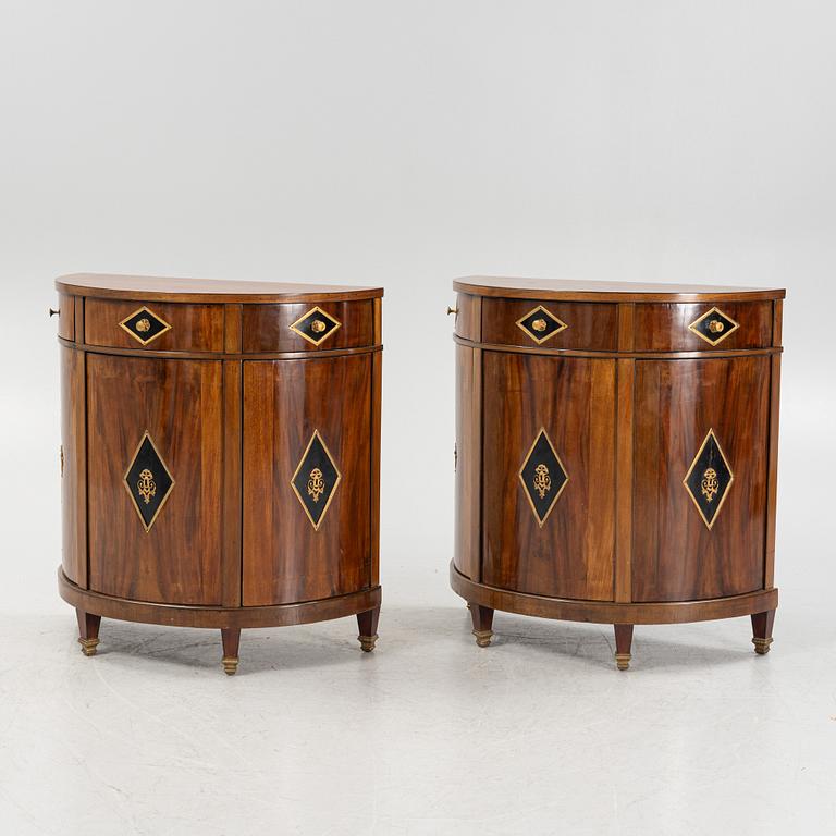 A pair of mahogany veneered empire style cabinets.