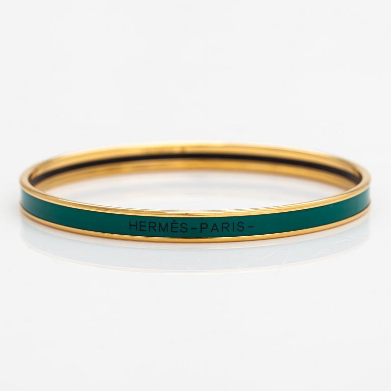 Hermès, a bracelet made of gold coloured metal and green enamel. Marked Hermès Paris, Made in France.