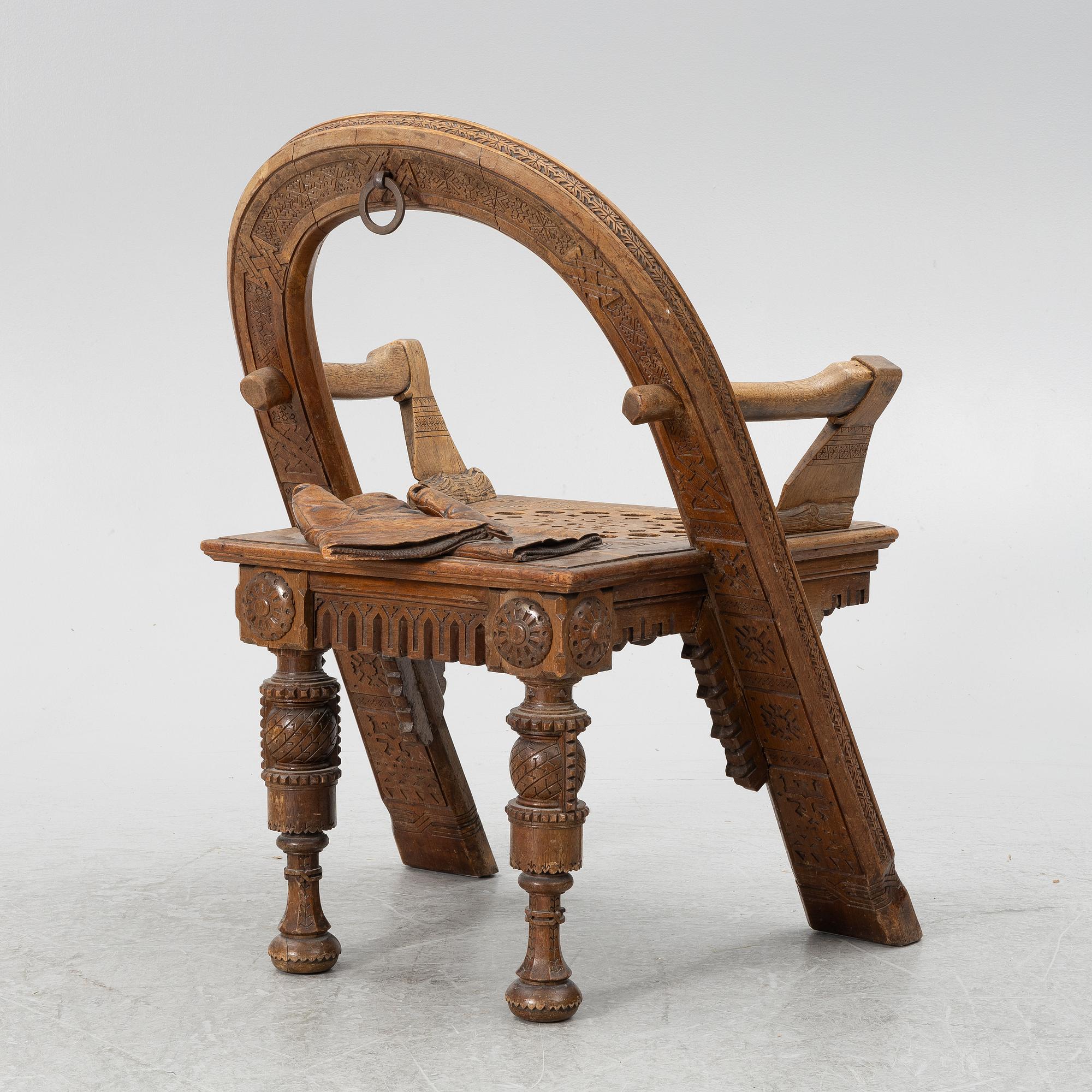 Armchair, after a design by Vasily Shutov called 'Arc, Axes and Mittens' Russia late 19th century.