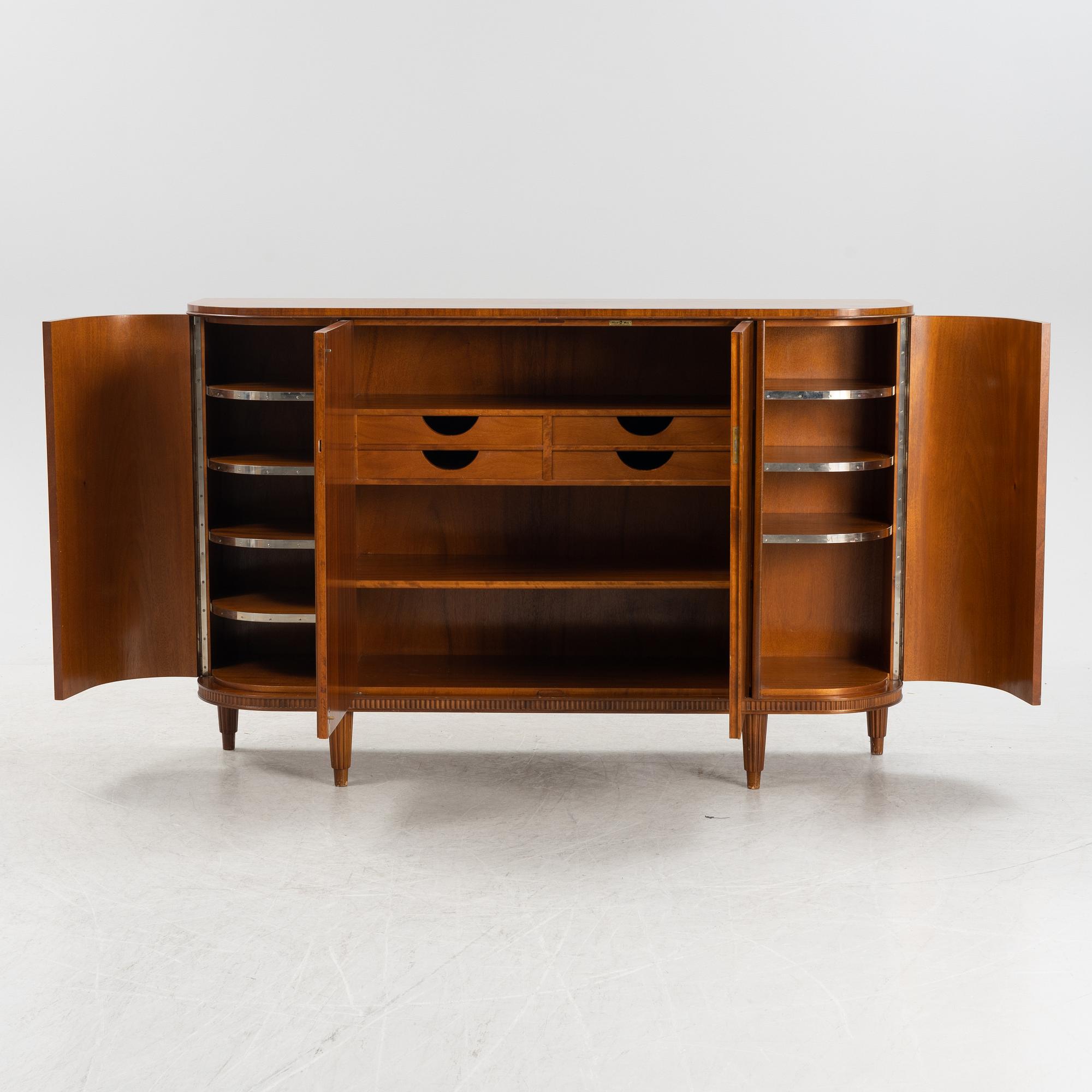 A 1940s mahogany veneered cabinet.