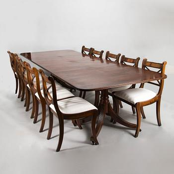 A dinner table and thirteen chairs, England, latter half of the 20th-century. Chairs marked Rosjohn,