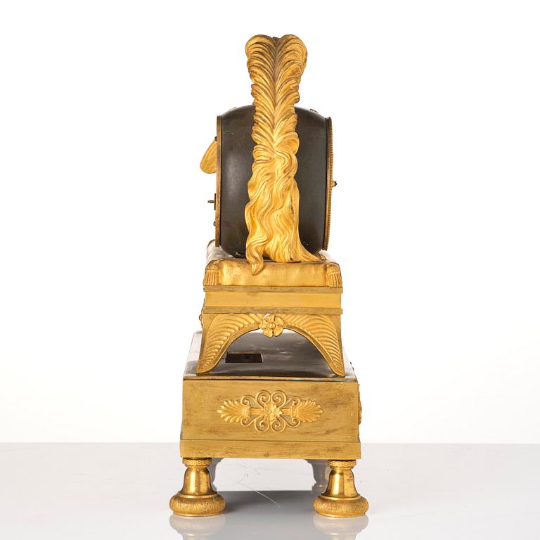 A French Empire sculptural ormolu and patinated bronze mantel clock, early 19th century.