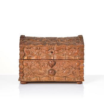 A baroque wedding casket, carved wood, dated 1725.