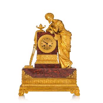 127. A French Empire ormolu and marble mantel clock 'à la sultane', first part of the 19th century.