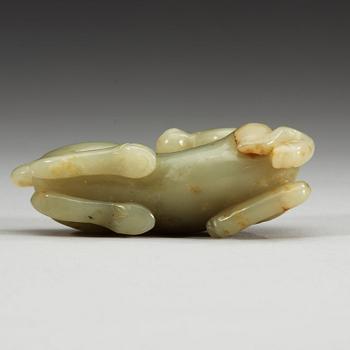 A carved nephrite figure of a reclining horse.